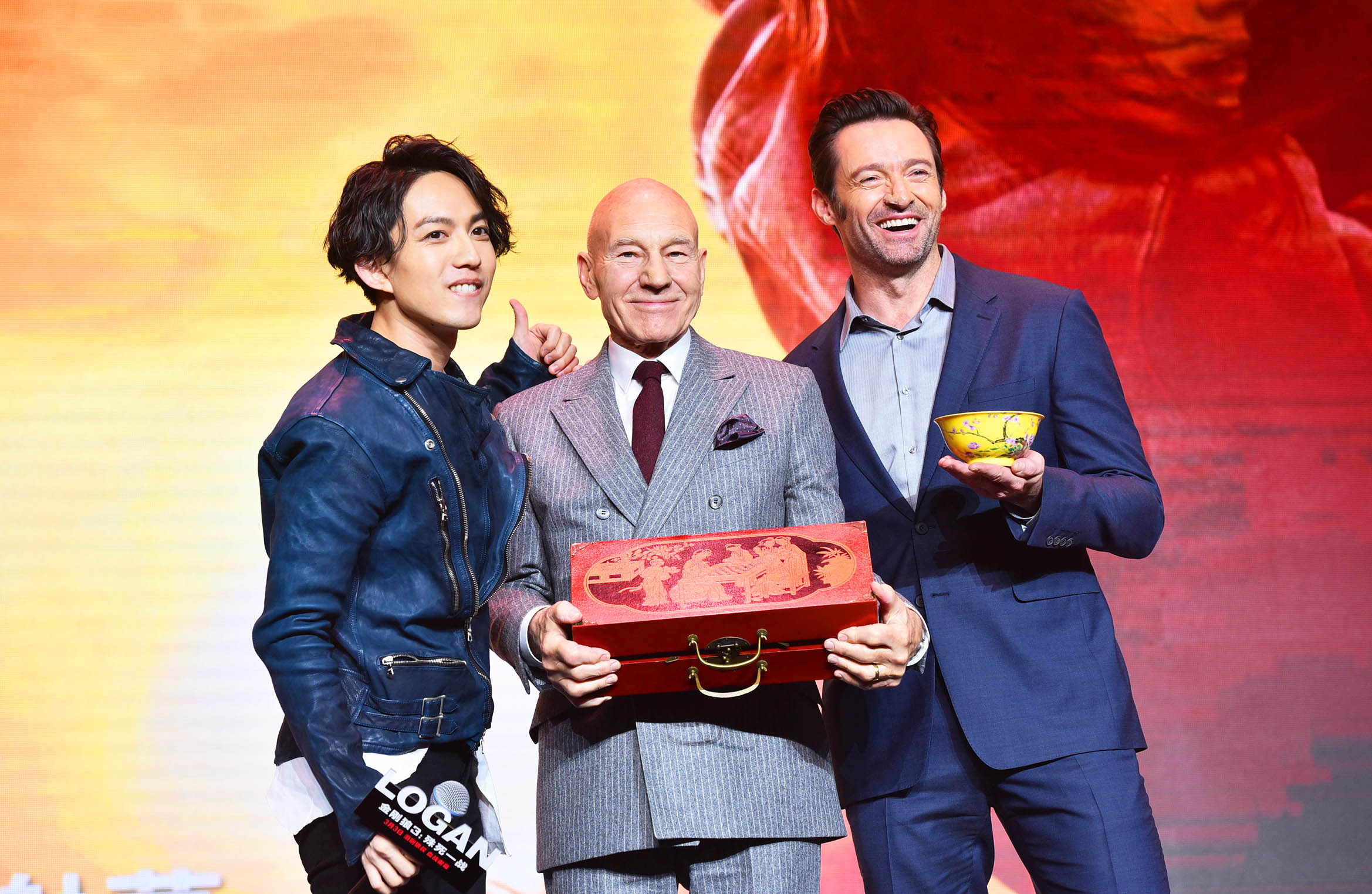 "Wolverine" Hugh Jackman (right), Patrick Stewart (center) pose together for a picture with a young Chinese singer who's a fan (left) on Wednesday afternoon, March 1, 2017, at a promotional event in Beijing held for 'Logan', the last film in the "Wolverine" franchise. [Photo provided to China Plus]
