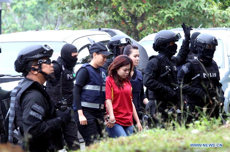 Indonesian national Siti Aisyah (the girl in red) enters the Sepang court as she is escorted with Malaysia special armed forces in Sepang, Malaysia, on March 1, 2017. Two female suspects, one from Indonesia and the other a Vietnamese, were charged on Wednesday with the murder of a man from the Democratic People's Republic of Korea (DPRK), said a local court in Malaysia. [Photo: Xinhua/Chong Voon Chung]