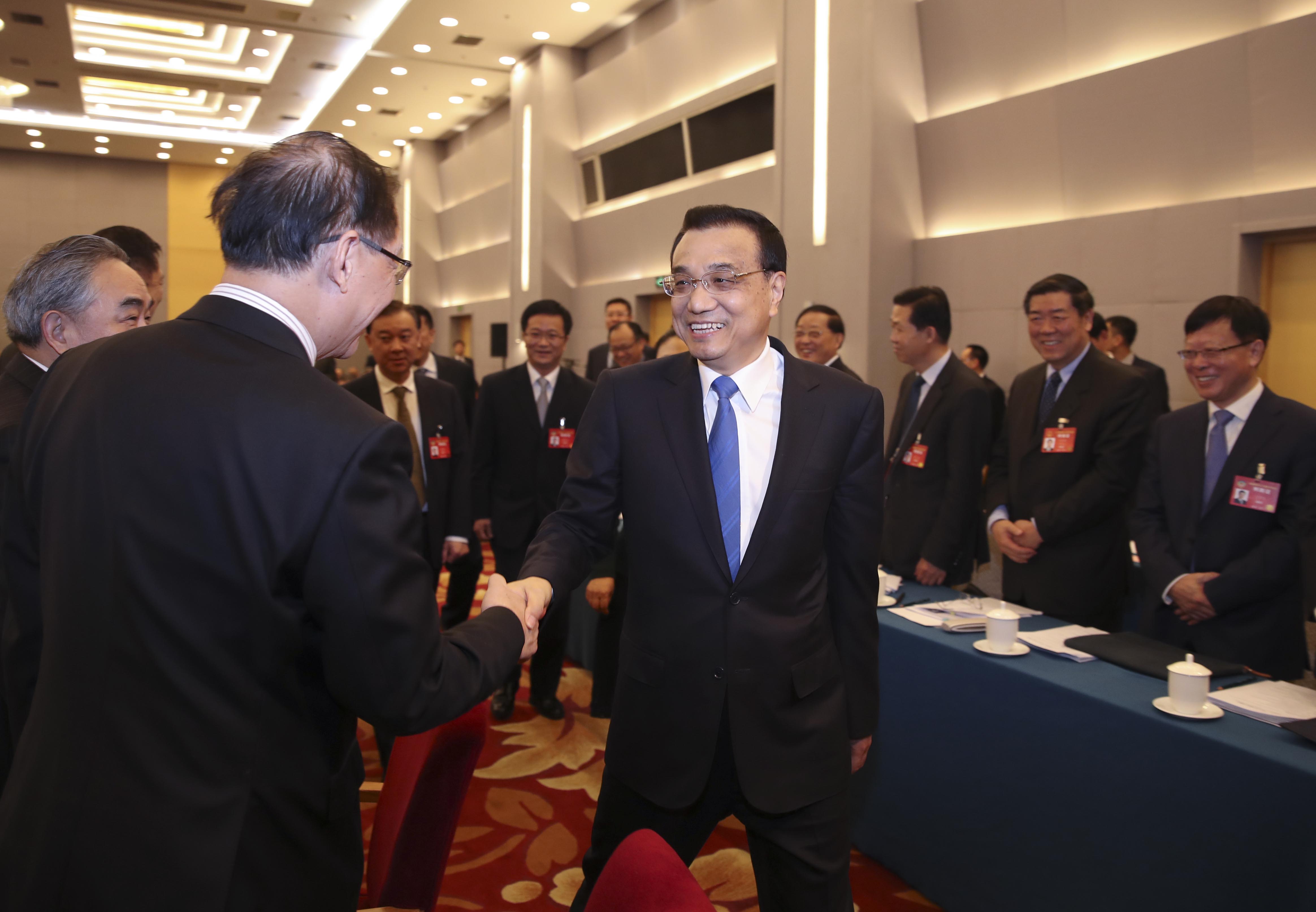 Premier Li Keqiang visiting members from business and agricultural communities attending the Fifth Session of the 12th National Committee of the Chinese People's Political Consultative Conference (CPPCC) on Saturday, March 04, 2017. Li participated in the joint discussion of the CPPCC members and listened to their opinions and proposals on property rights protection, prices of agricultural products, and the development of the private economy. [Photo: China Plus]