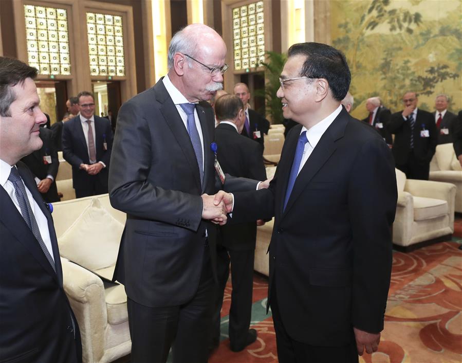 Chinese Premier Li Keqiang (R, front) shakes hands with Dieter Zetsche, chairman of Daimler AG and head of Mercedes-Benz Cars, when meeting with foreign representatives of the China Development Forum (CDF) 2017 in Beijing, capital of China, March 20, 2017. [Photo: Xinhua]