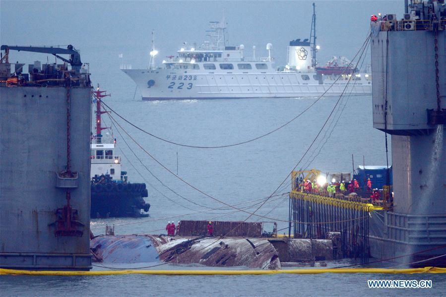 The sunken passenger ferry Sewol is raised during its salvage operations on the sea off Jindo Island,South Korea, March 23, 2017. The ill-fated vessel with 476 passengers on board capsized and sank off the Jindo Island, South Jeolla province on April 16, 2014. The Sewol has lain in waters off southeastern South Korea for almost three years. [Photo: Xinhua]