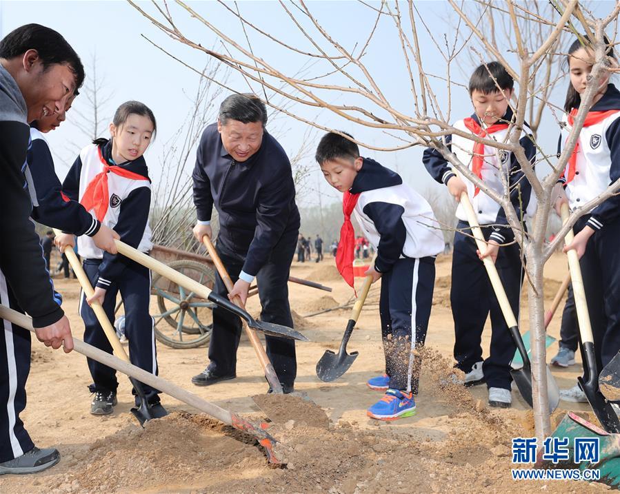 Chinese President Xi Jinping plants trees with students on Tuesday March 29 in east Beijing. [Photo: Xinhua]