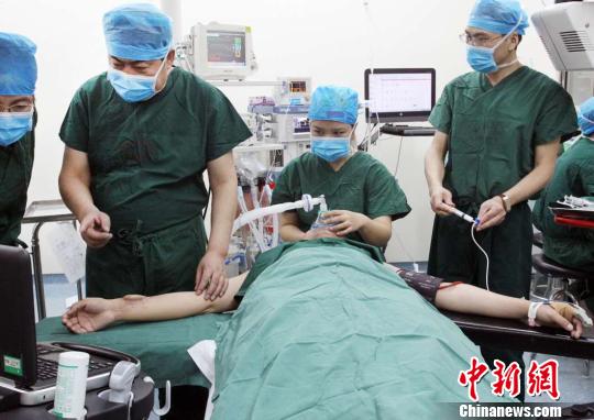 Plastic surgeons from First Affiliated Hospital of Xi'an Jiaotong University transplanting a regenerated ear from a patient's arm to his head, March 29, 2017. [Photo: Chinanews.com]  
