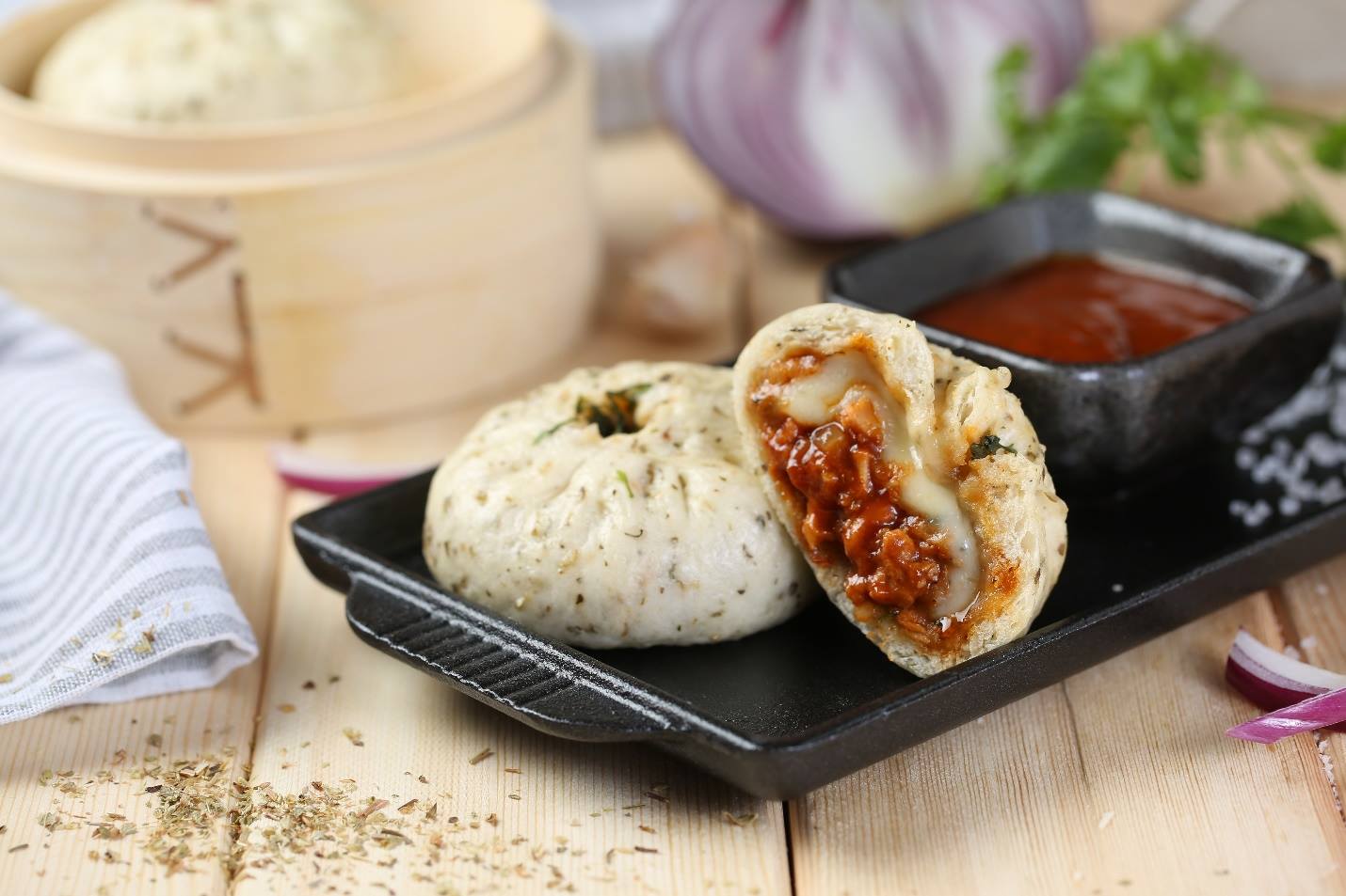 Traditional Chinese steamed buns called "Baozi" with meat filling have been redesigned by innovative entrepreneurs Alex Cree and Loren Heinold, using a savory steamed dough and filling it with pizza ingredients. [Photos: Baozza/Alex Cree]