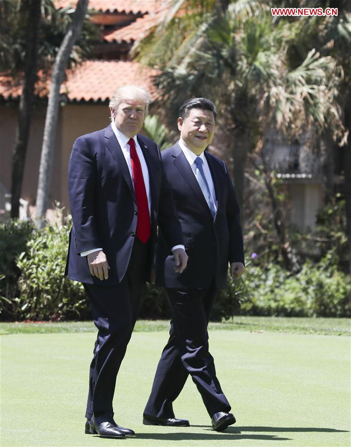 Chinese President Xi Jinping (R) and his U.S. counterpart Donald Trump take a walk to further discuss bilateral cooperation issues in the Mar-a-Lago resort in Florida, the United States, April 7, 2017. The two leaders held their second round of talks here on Friday. [Photo: Xinhua/Lan Hongguang]