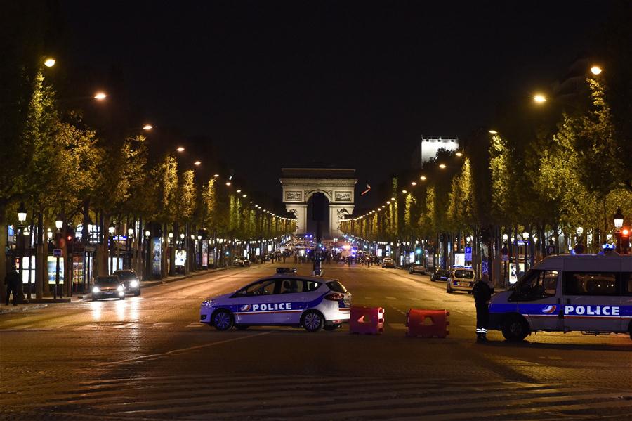 Police vehicles block the Champs Elysees shopping street in Paris, France on April 20, 2017. One policeman was killed, and another severely injured in a shooting incident Thursday evening near the Champs Elysees shopping street in Paris.[Photo: Xinhua] 