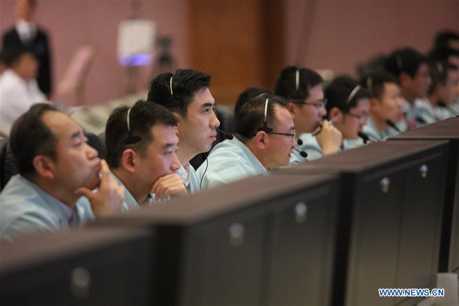 Technical personnel work at Beijing Aerospace Control Center to monitor the automated docking between Tianzhou-1 cargo spacecraft and Tiangong-2 space lab in Beijing, capital of China, April 22, 2017. [Photo: Xinhua/Yu Tao]