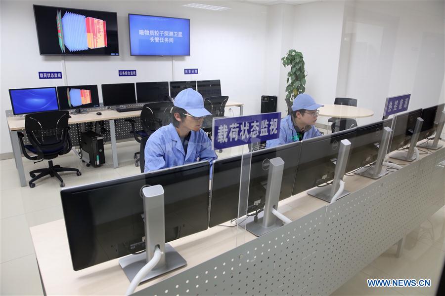Personnel with the National Space Science Centre under the Chinese Academy of Sciences (CAS), work with the Dark Matter Particle Explorer (DAMPE) Satellite, "Wukong," in Beijing on December 24, 2015. [Photo: Xinhua]