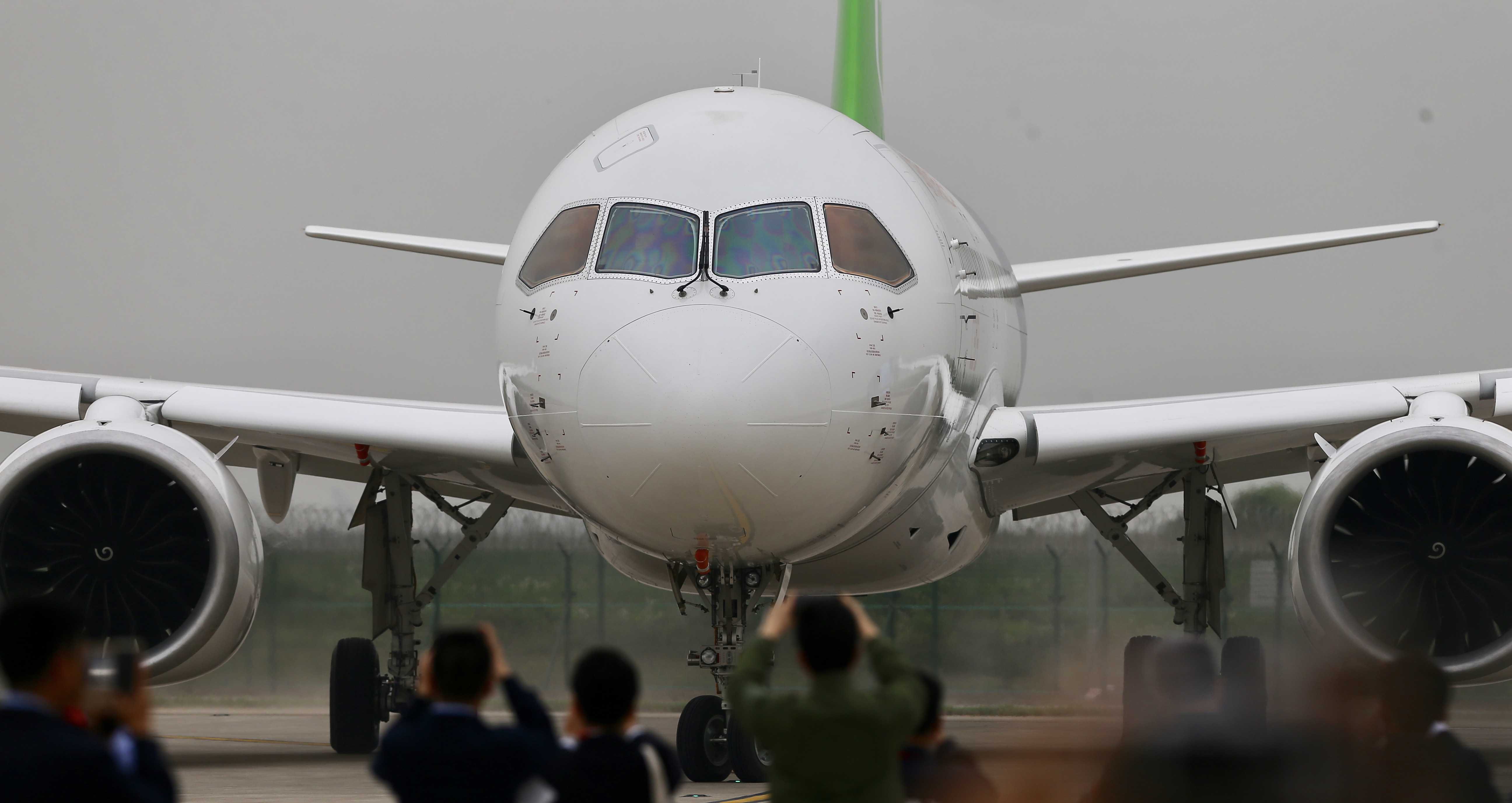 The C919, the first Chinese-made large passenger plane, lands at Shanghai Pudong International Airport, after successfully undertaking its maiden flight on Friday, May 5, 2017. [Photo: China Plus / Li Jin]