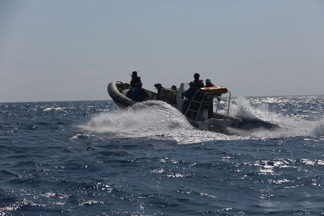 Chinese marine law enforcement personnel take a small boat to land on one of the Xisha islands in the South China Sea, in April 2017. [Photo: scsb.gov.cn]