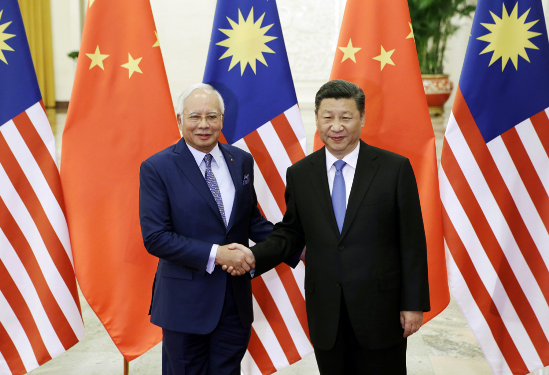 Malaysian Prime Minister Najib Razak, left, poses with Chinese President Xi Jinping before a meeting ahead of the Belt and Road Forum in Beijing Friday, May 13, 2017. [Photo: Pool Photo via AP/Jason Lee]