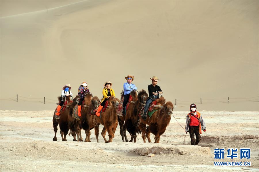 Travellers on horseback visit Dunhuang, a major stop on the ancient Silk Road as well as a tourist city further boosted by the Belt and Road Initiative. [Photo: Xinhua]