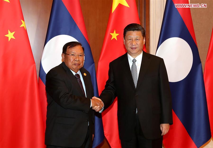 Xi Jinping (R), general secretary of the Central Committee of the Communist Party of China and Chinese president, meets with Bounnhang Vorachit, general secretary of the Central Committee of the Laotian People's Revolutionary Party and Laotian president, in Beijing, capital of China, May 16, 2017. [Photo: Xinhua]