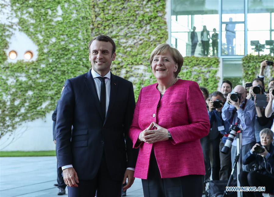 German Chancellor Angela Merkel (R) poses for photos with visiting French President Emmanuel Macron in Berlin, capital of Germany, on May 15, 2017. [Photo: Xinhua]