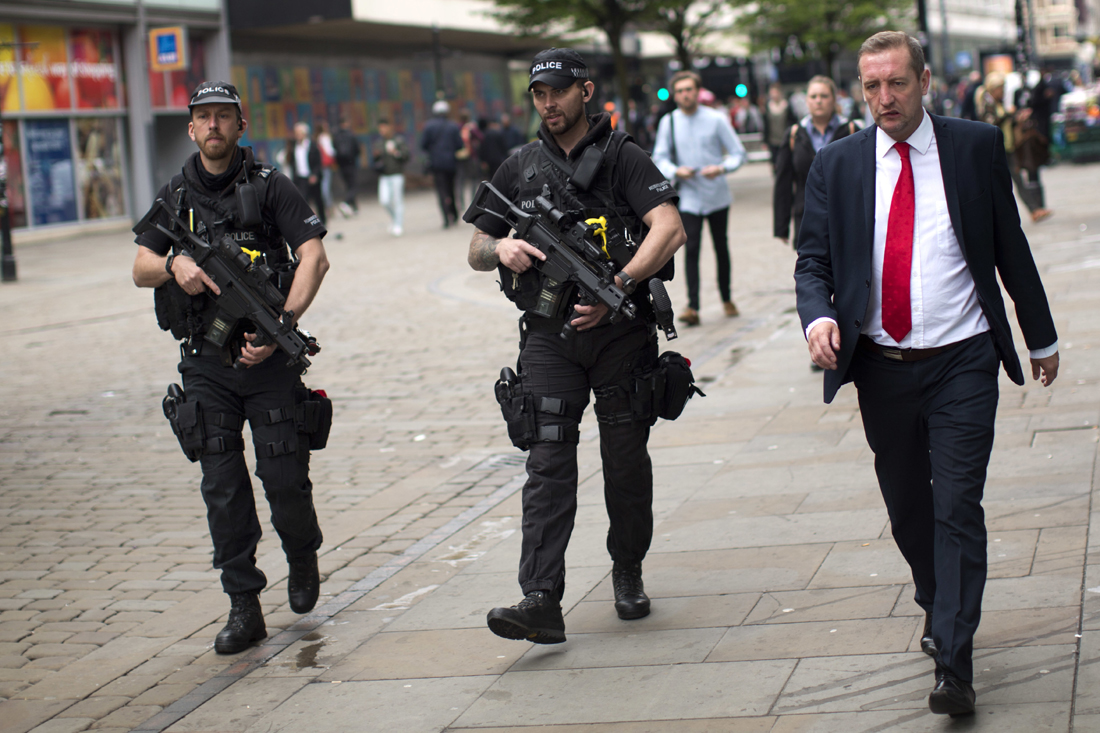 Police officers patrol in central Manchester, Britain, Wednesday, May 24, 2017 after Monday's suicide attack at an Ariana Grande concert. Britons will find armed troops at vital locations Wednesday after the official threat level was raised to its highest point. [Photo: AP/Emilio Morenatti]