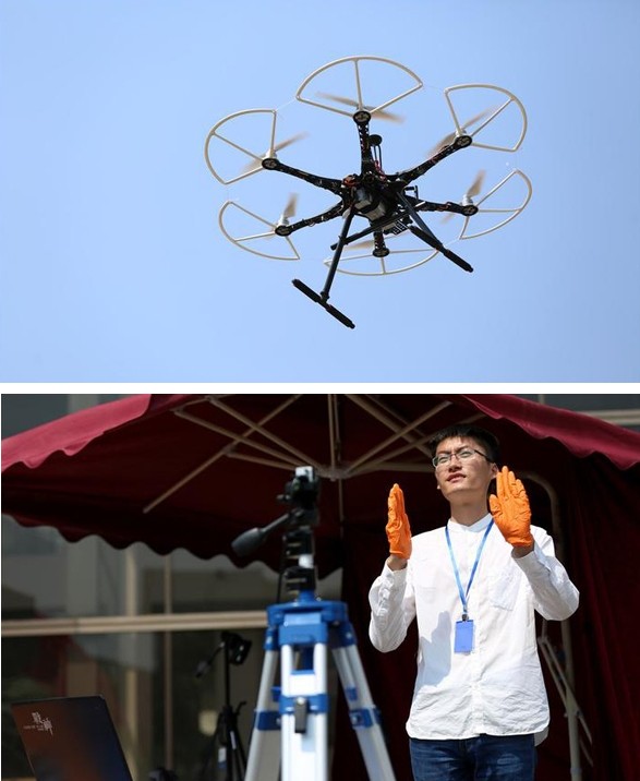 Researcher Hua Chunsheng operates a drone through gestures at the Shenyang Science and Technology Week. [Photo: 163.com]