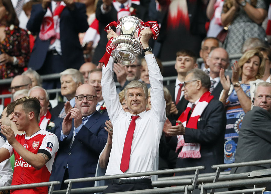 Arsenal team manager Arsene Wenger celebrates with the trophy after winning the English FA Cup final soccer match between Arsenal and Chelsea at Wembley stadium in London, Saturday, May 27, 2017. Arsenal won 2-1. [Photo/Kirsty Wigglesworth]