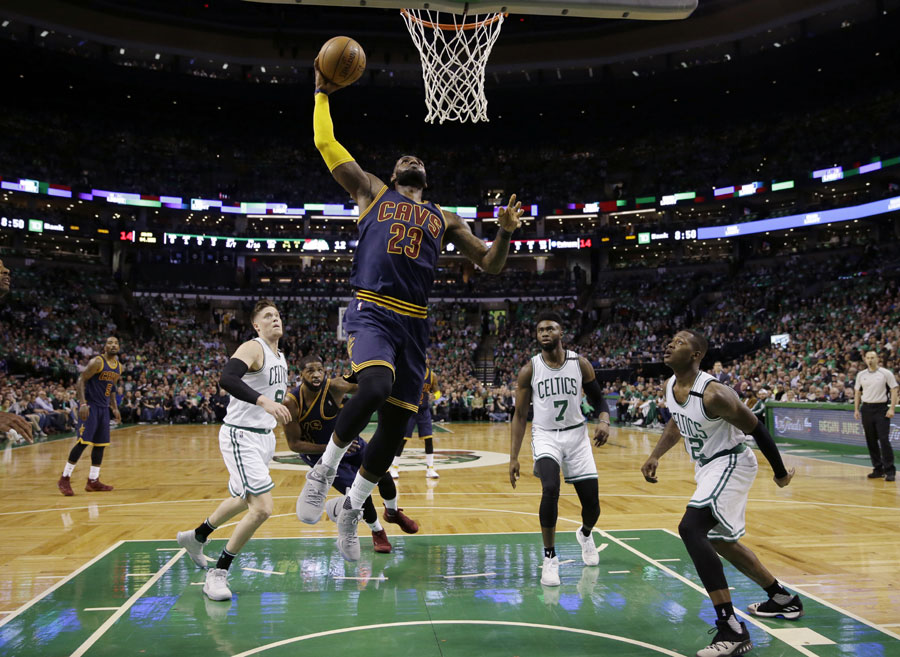 Cleveland Cavaliers forward LeBron James (23) soars to the basket over Boston Celtics forward Jonas Jerebko (8) forward Jaylen Brown (7) and guard Terry Rozier (12) during the first half of Game 5 of the NBA basketball Eastern Conference finals, on Thursday, May 25, 2017, in Boston. [Photo: AP/Charles Krupa]