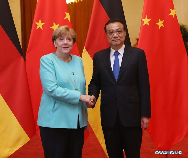 Chinese Premier Li Keqiang (R) shakes hands with German Chancellor Angela Merkel at a welcoming ceremony for Merkel before their talks at the Great Hall of the People in Beijing, June 13, 2016. [Photo: Xinhua]