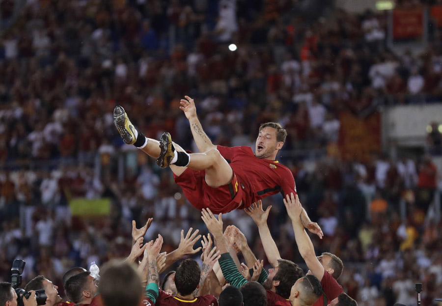 Roma's Francesco Totti is tossed in the air by his teammates after an Italian Serie A soccer match between Roma and Genoa at the Olympic stadium in Rome, Sunday, May 28, 2017. Francesco Totti played his final match with Roma against Genoa after a 25-season career with his hometown club. [Photo: AP/Alessandra Tarantino]