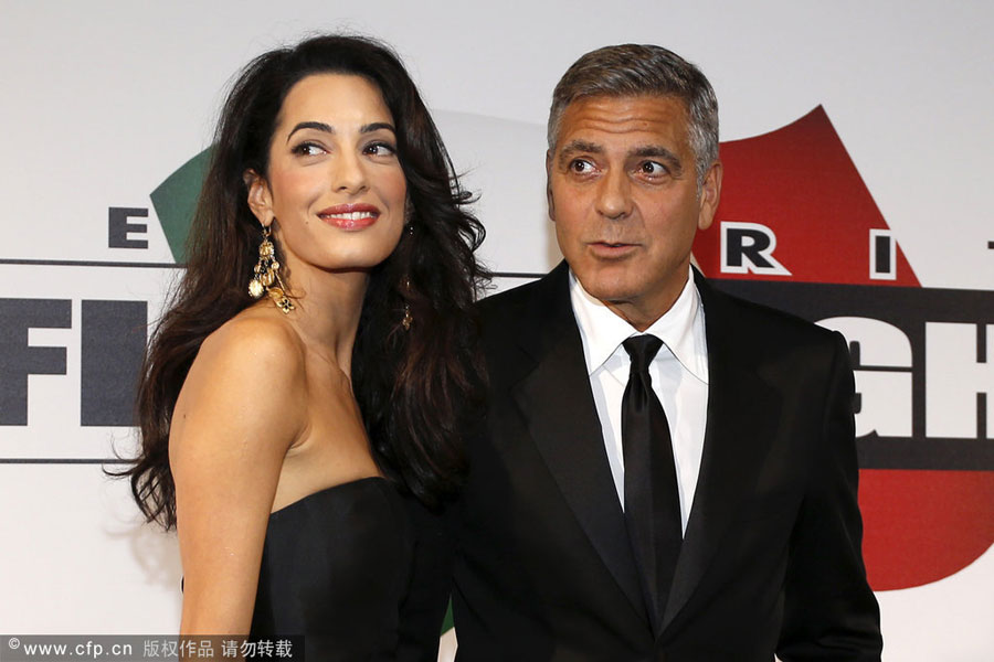 File photo of George Clooney and his wife Amal Alamuddin at the Celebrity Fight Night at the Palazzo Vecchio in Florence, Italy on September 7th, 2014. [Photo: actionpress/CFP]