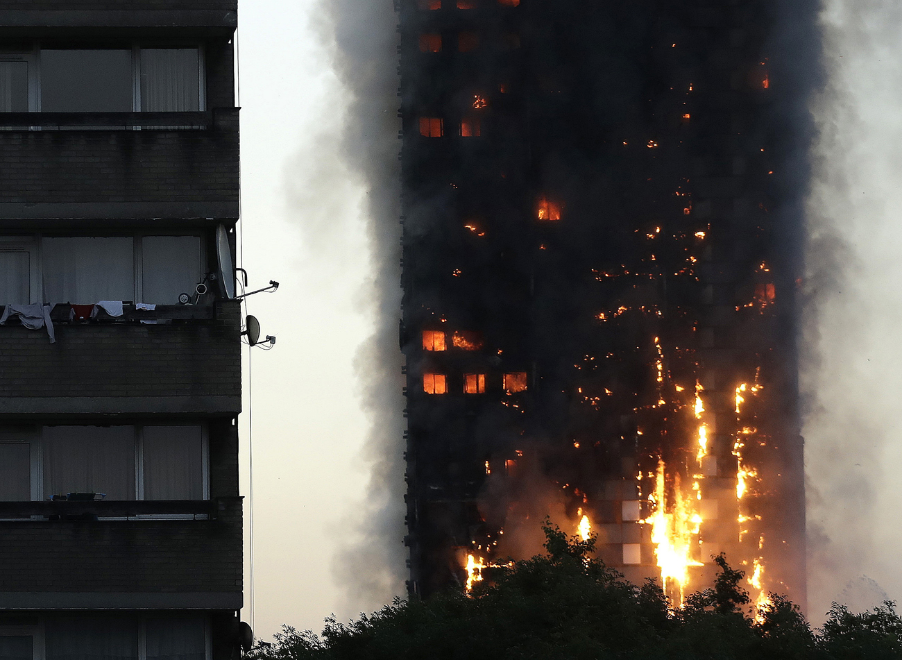 Smoke and flames rise from a building on fire in London, June 14, 2017. [Photo: AP/ Matt Dunham]