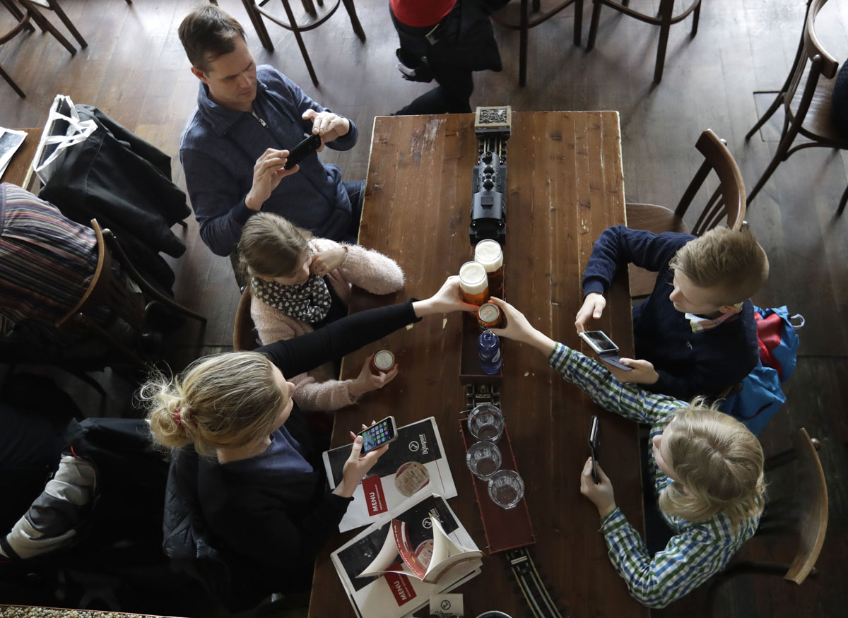 Costumers take drinks from a model freight train in a restaurant in Prague, Czech Republic, Wednesday, April 19, 2017. [Photo: AP/Petr David Josek]