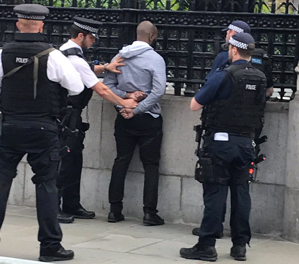 Police officers detain a man outside the Palace of Westminster, in central London, Britain June 16, 2017. [Photo: VCG]