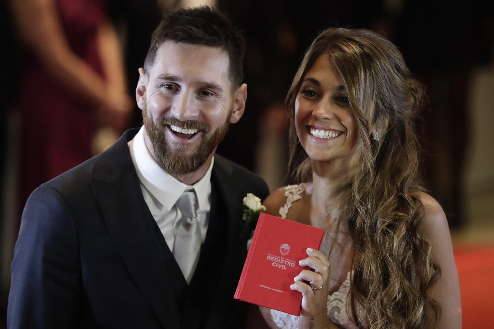 Newlyweds Lionel Messi and Antonella Roccuzzo pose for photographers after tying the knot in Rosario, Argentina, Friday, June 30, 2017. About 250 guests, including teammates and former teammates of the Barcelona star, attended the highly anticipated ceremony. [Photo: AP/Victor R. Caivano]