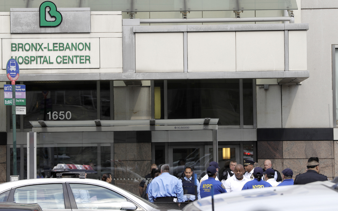 Officials are gathered outside Bronx Lebanon Hospital in New York after a gunman opened fire there on Friday, June 30, 2017. The gunman, identified as Dr. Henry Bello who used to work at the hospital, returned with a rifle hidden under his white lab coat, law enforcement officials said. [Photo: AP/Julio Cortez]