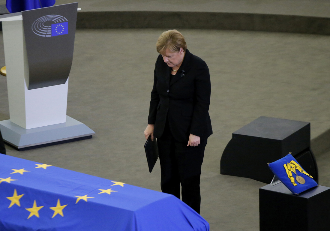 German Chancellor Angela Merkel pays her respects to former German Chancellor Helmut Kohl, at the European Parliament in Strasbourg, eastern France, Saturday July 1, 2017. Current and former world leaders gathered Saturday to bid farewell to Kohl, recalling him as a man who was instrumental in uniting Europe and bringing about reconciliation between former adversaries on the continent. [Photo: AP/Michel Euler]