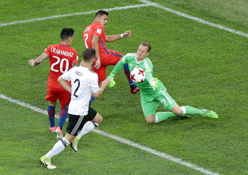 Germany goalkeeper Bernd Leno, right, makes a save next to Chile's Alexis Alejandro Sanchez, top and Charles Mariano Aranguiz Sandoval, left, during the Confederations Cup final soccer match between Chile and Germany, at the St.Petersburg Stadium, Russia, Sunday, July 2, 2017. [Photo: AP/Dmitri Lovestky]