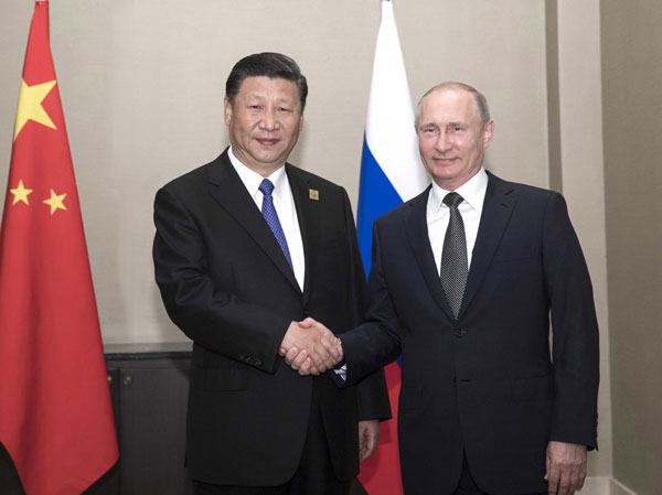 President Xi Jinping (L) meets with Russian President Vladimir Putin in Astana, Kazakhstan, June 8, 2017. [Photo: Xinhua]