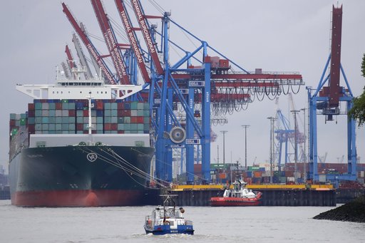 Ferry boats pass the container ship 'ThalassaTyhi' of China at the container terminal of the harbor of Hamburg, Germany, Saturday, July 1, 2017. [Photo: AP/Matthias Schrader]