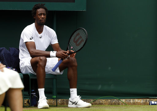 Gael Monfils of France sits on the chair of a line judge during his Men's Singles Match against Germany's Daniel Brands on day two at the Wimbledon Tennis Championships in London Tuesday, July 4, 2017. [Photo: AP/Kirsty Wigglesworth]
