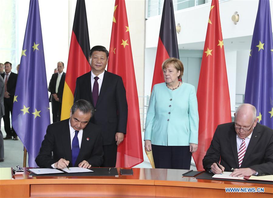 Chinese President Xi Jinping and German Chancellor Angela Merkel attend a signing ceremony after their talks in Berlin, capital of Germany, July 5, 2017. [Photo: Xinhua/Ma Zhancheng]