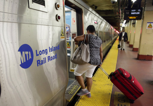 In this July 15, 2014 file photo, passengers board a Long Island Rail Road train, in New York's Penn Station.[Photo: AP/Richard Drew]