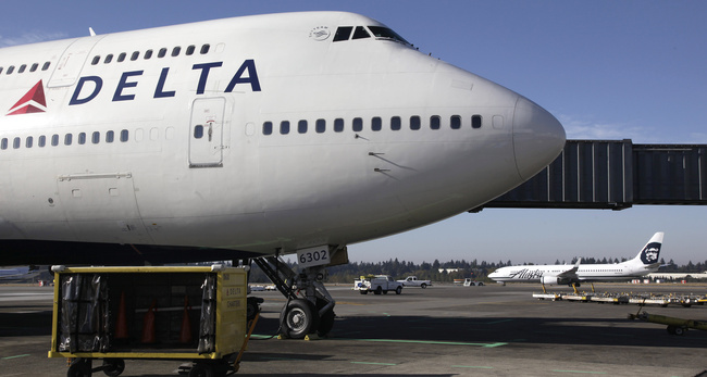 In this Oct. 9, 2012 file photo, Delta Air Lines 747-400 airplane sits parked at Seattle-Tacoma International Airport in Seattle.[Photo: AP]
