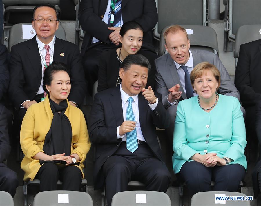 Chinese President Xi Jinping (C, front), his wife Peng Liyuan (L, front) and German Chancellor Angela Merkel (R, front) watch a friendly football match between Chinese and German youth teams in Berlin, capital of Germany, July 5, 2017. [Photo: Xinhua/Wang Ye]