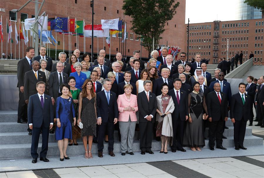 Leaders attending the Group of 20 summit and their spouses pose for a group photo in Hamburg, Germany, July 7, 2017. The 12th Summit of the Group of 20 (G20) major economies was held in Hamburg on Friday. [Photo: Xinhua/Yao Dawei]