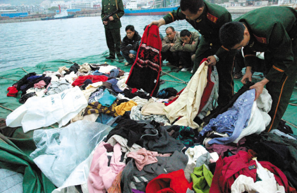 File photo of officials inspecting foreign garbage. [Photo: China.com]