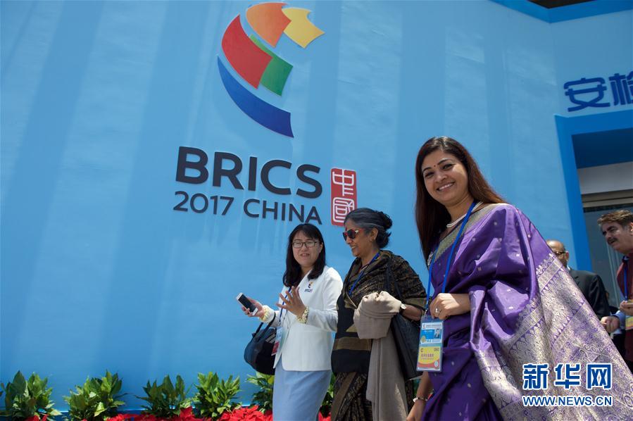 File photo of foreign delegates walking pass a BRICS sign.[Photo: Xinhua]