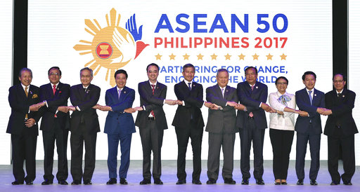 ASEAN Foreign Ministers link hands "The ASEAN Way" at the opening ceremony of the 50th ASEAN Foreign Ministers Meeting at the Philippine International Convention Center Saturday, Aug. 5, 2017. [Photo: AP/Mohd Rasfan]