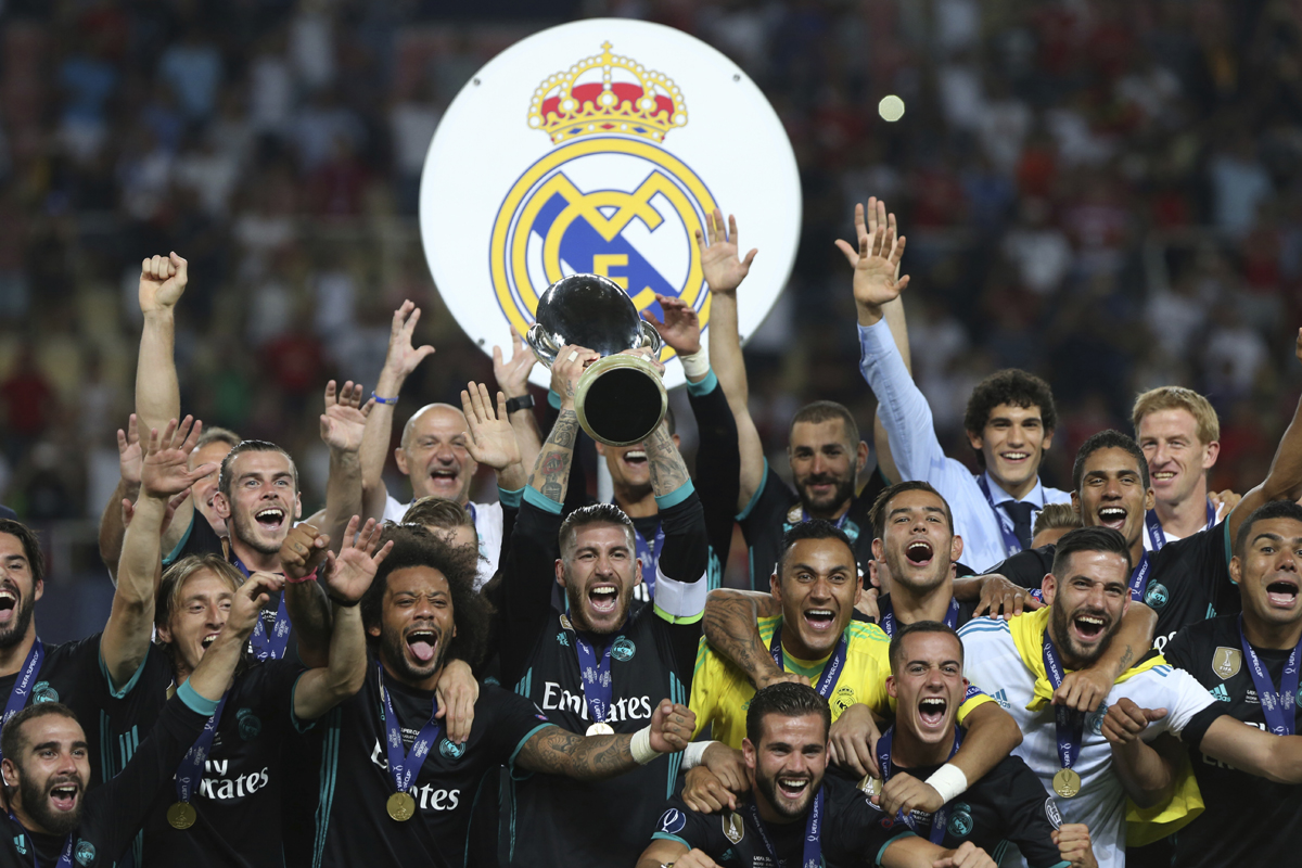 Real Madrid celebrate with the trophy after defeating Manchester United 2-1 during the Super Cup final soccer match at Philip II Arena in Skopje, Tuesday, Aug. 8, 2017. [Photo: AP]
