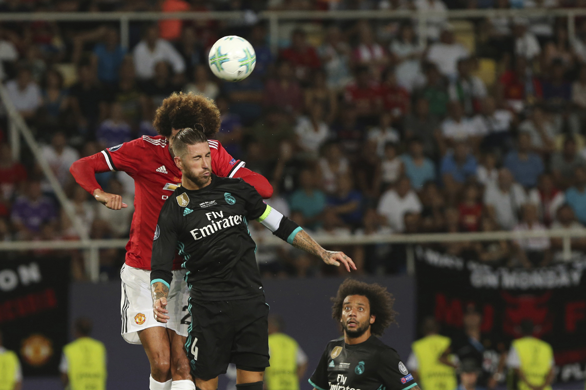 Manchester United's Marouane Fellaini ,and Real Madrid's Sergio Ramos, front, challenge for a header during the UEFA Super Cup final soccer match between Real Madrid and Manchester United at Philip II Arena in Skopje, Tuesday, Aug. 8, 2017. [Photo: AP]