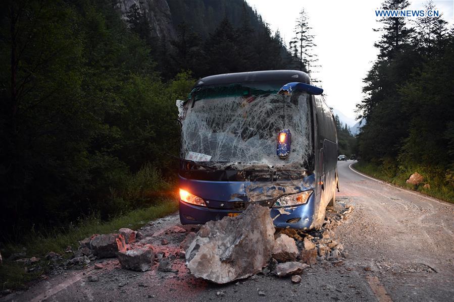 A bus is destroyed by falling stones on the S301 highway in quake-hit Jiuzhaigou County, southwest China's Sichuan Province, Aug. 9, 2017. A 7.0-magnitude earthquake struck the popular tourist destination Tuesday night. [Photo: Xinhua/Fan Peishen]