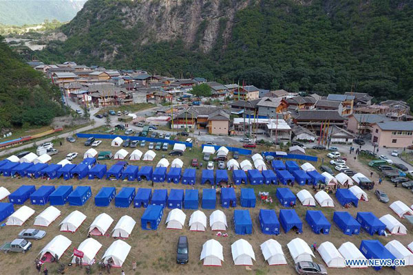 Photo taken on August 11, 2017 shows tents at a temporary shelter in Zhangzha Village of Zhangzha Town in Jiuzhaigou County, southwest China's Sichuan Province. Temporary shelters have been established in Jiuzhaigou after a 7.0-magnitude earthquake strikes Jiuzhaigou County on August 8, 2017. Quake-affected people receive relief supplies and start their lives in tents. [Photo: Xinhua/Xue Yubin]