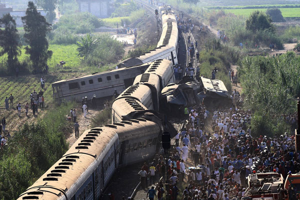 A general view of people by the wreckage after two passenger trains collide in Alexandria, Egypt, on August 11, 2017. [Photo: Imagine China]