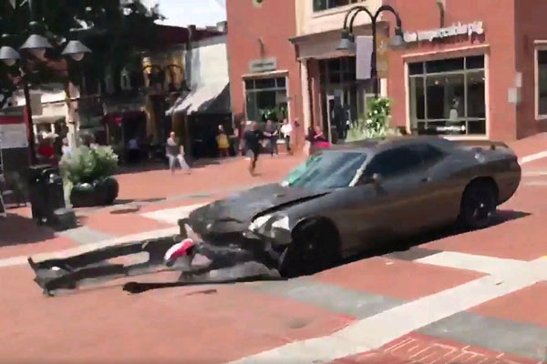 A video grab made available shows a car reversing after hitting a crowd in Charlottesville, Virginia, USA, on August 12, 2017. [Photo: Imagine China]