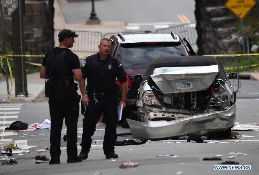 Police work at the car crash site following a violent white nationalist rally in Charlottesville, Virginia, the United States, Aug. 12, 2017. At least one person was killed in a multiple car crash following a violent white nationalist rally on Saturday in Charlottesville in Virginia, Charlottesville Mayor Michael Signer said. [Photo: Xinhua/Yin Bogu]